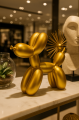 Złota figurka piesek balonowy na wystawie sklepowej